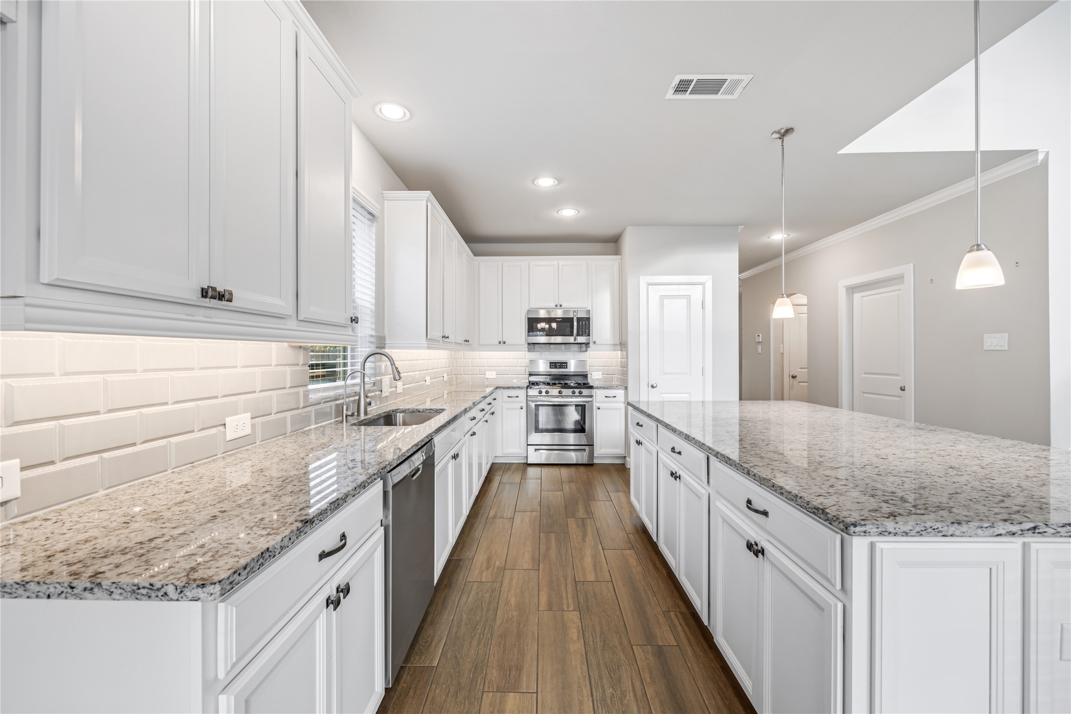 3604 Magnolia Crest Lane Spring, TX 77386 - Photo 14 of 50 a kitchen with granite countertop kitchen island a sink a counter space stainless steel appliances and cabinets