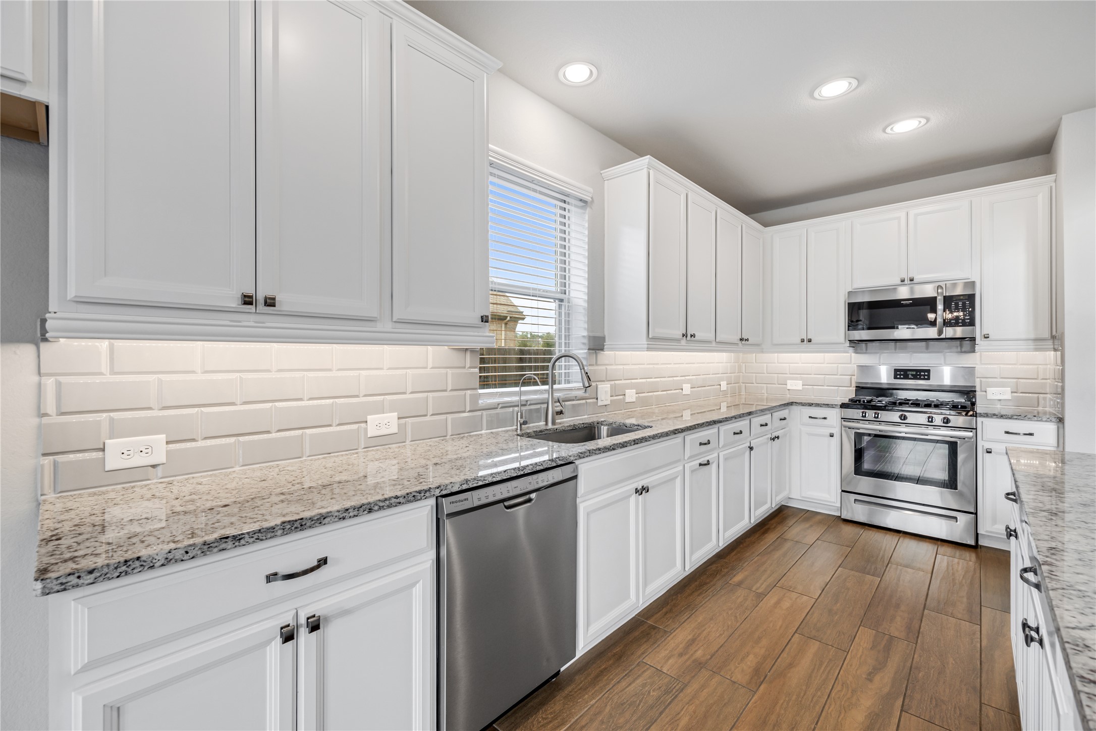 3604 Magnolia Crest Lane Spring, TX 77386 - Photo 16 of 50 a kitchen with kitchen island granite countertop a sink stainless steel appliances and cabinets