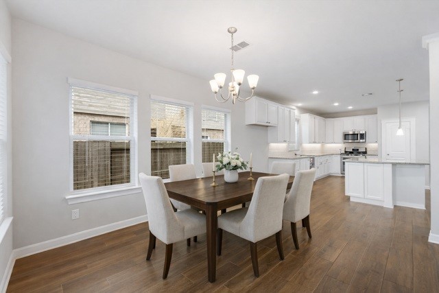 3604 Magnolia Crest Lane Spring, TX 77386 - Photo 19 of 50 a view of a dining room with furniture a chandelier and wooden floor
