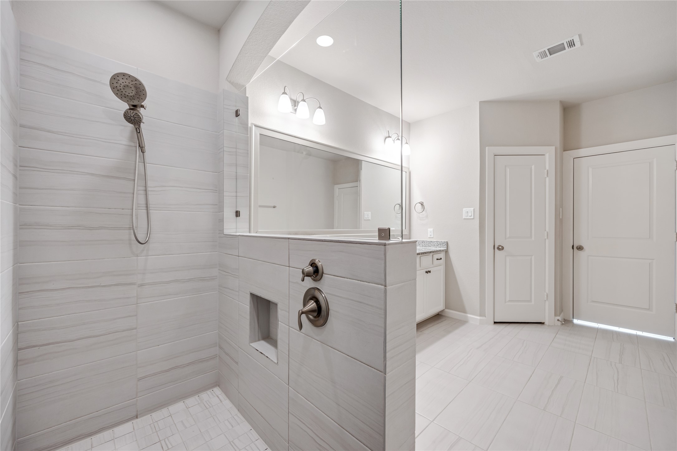 3604 Magnolia Crest Lane Spring, TX 77386 - Photo 29 of 50 a bathroom with a bathtub a shower a sink and a mirror