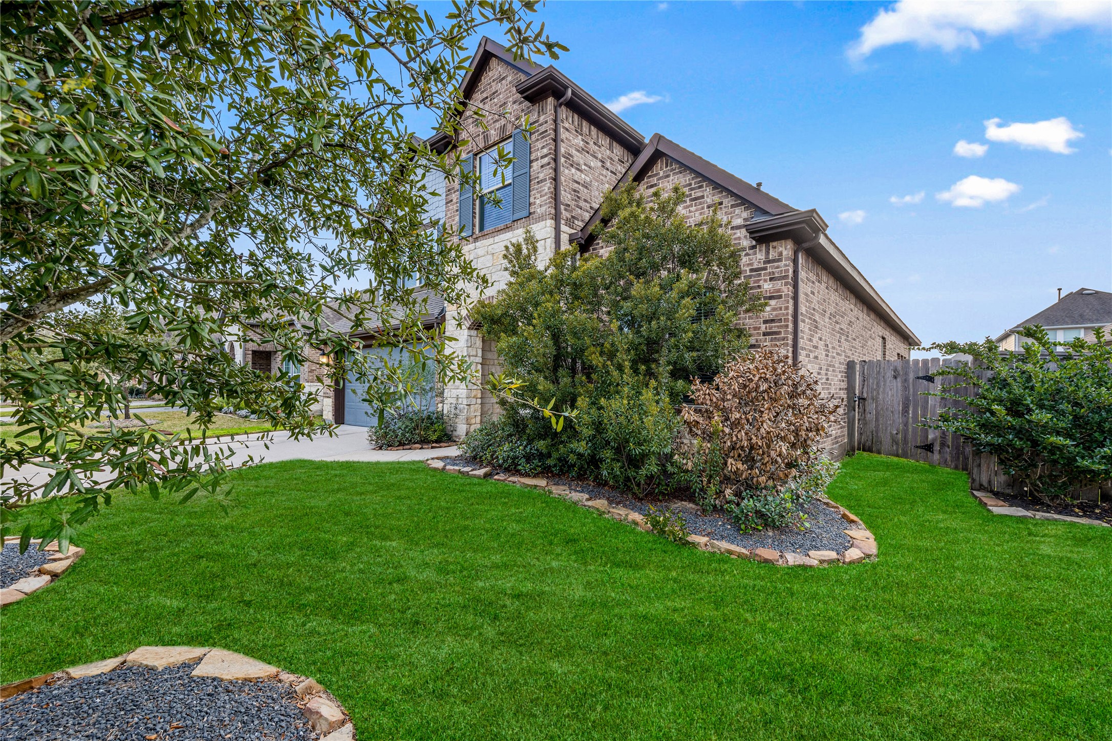 3604 Magnolia Crest Lane Spring, TX 77386 - Photo 4 of 50 Stunning two-story brick home with a well-maintained lawn and lush landscaping. The property features a fenced backyard.