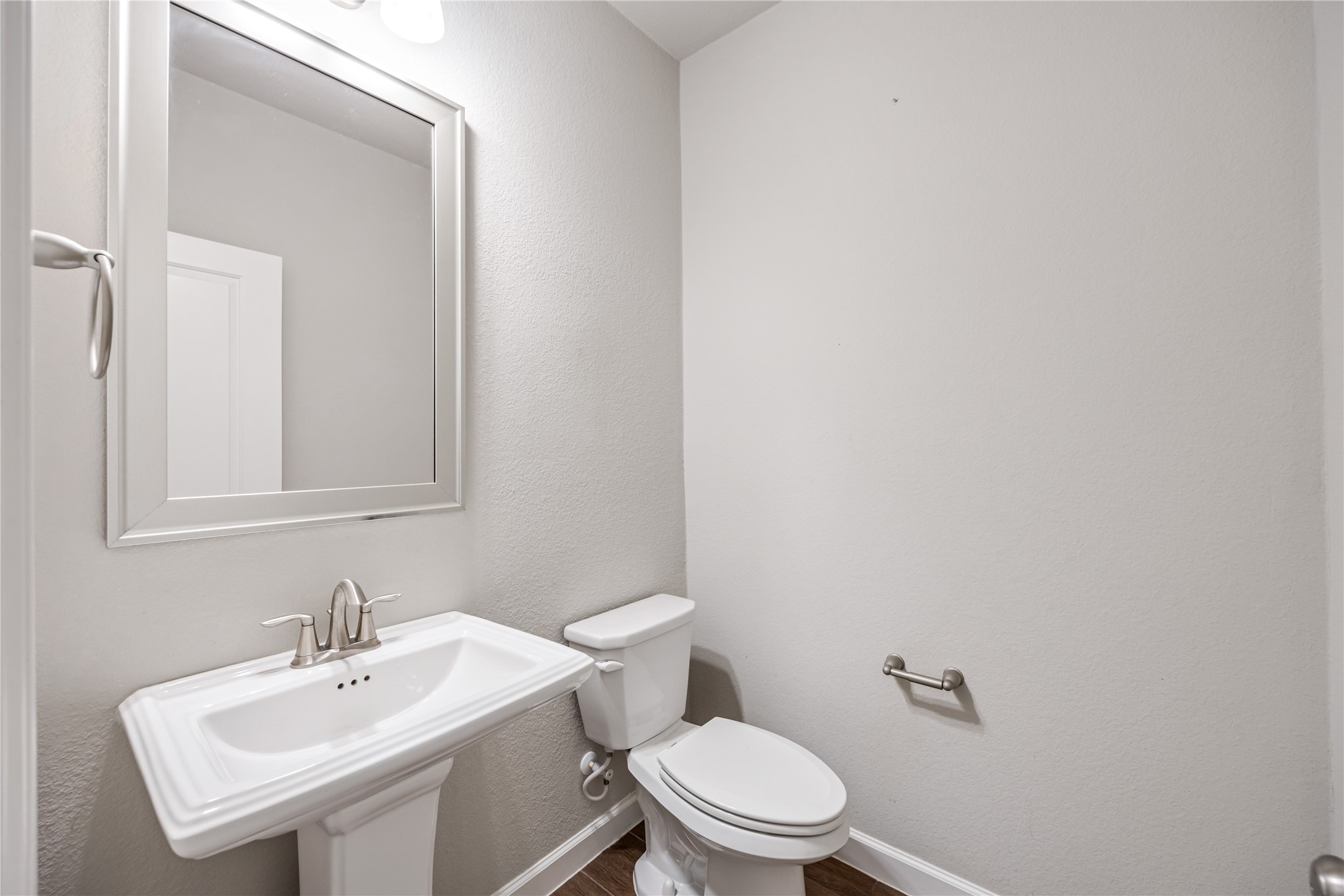 3604 Magnolia Crest Lane Spring, TX 77386 - Photo 9 of 50 a white toilet sitting next to a bathroom sink