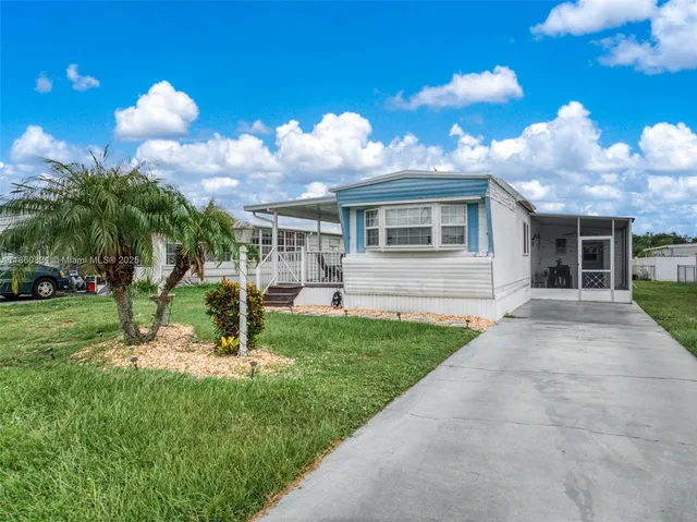 a view of a house with a yard and a garden
