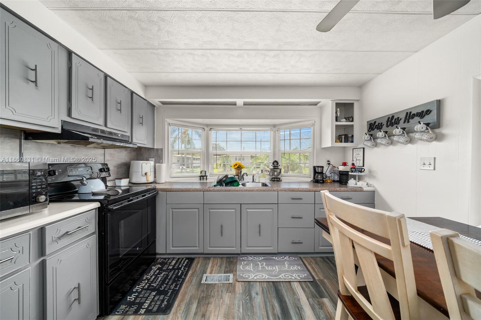 3208 Delaware Avenue Sebring, FL 33870 - Photo 11 of 37 a kitchen with granite countertop cabinets stainless steel appliances a sink and a window
