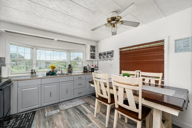 a kitchen with stainless steel appliances kitchen island granite countertop a sink and cabinets