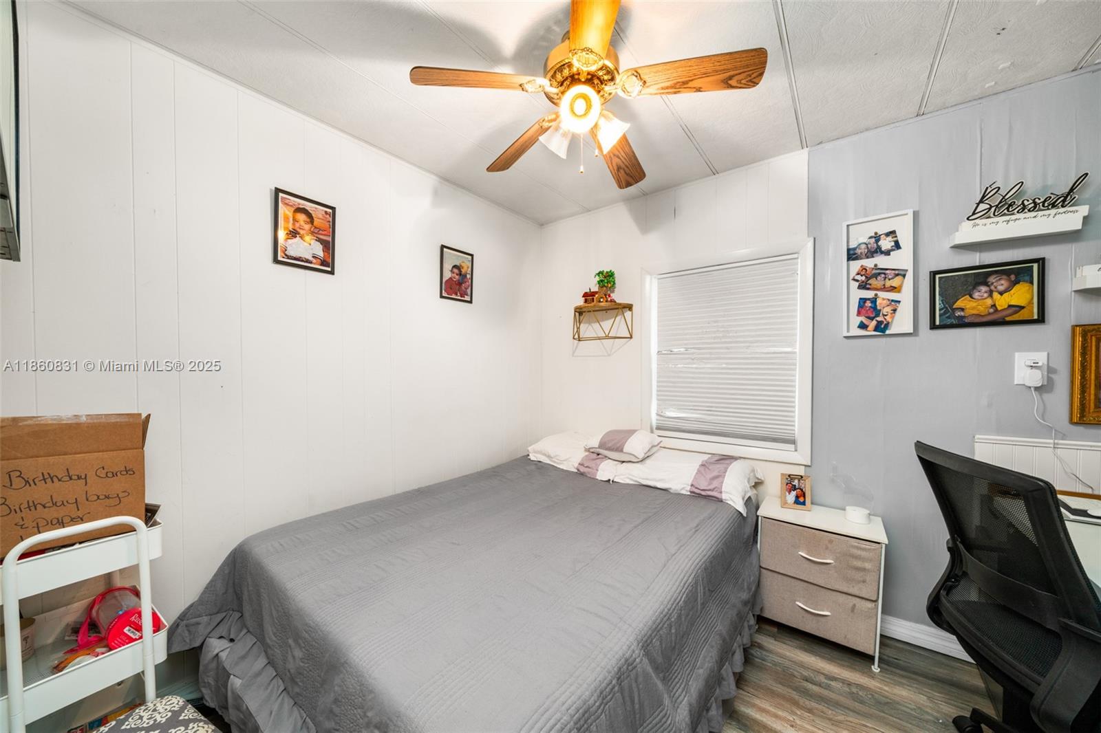 3208 Delaware Avenue Sebring, FL 33870 - Photo 15 of 37 a bedroom with a bed and a chandelier