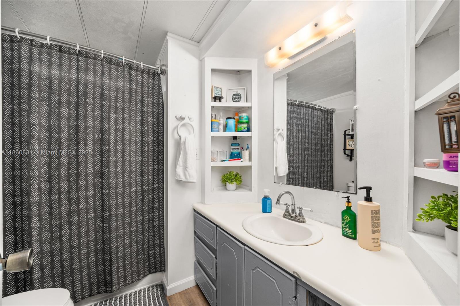 3208 Delaware Avenue Sebring, FL 33870 - Photo 17 of 37 a bathroom with a sink a toilet and shower