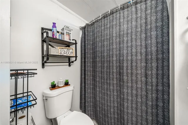 a white toilet sitting next to a bathroom sink