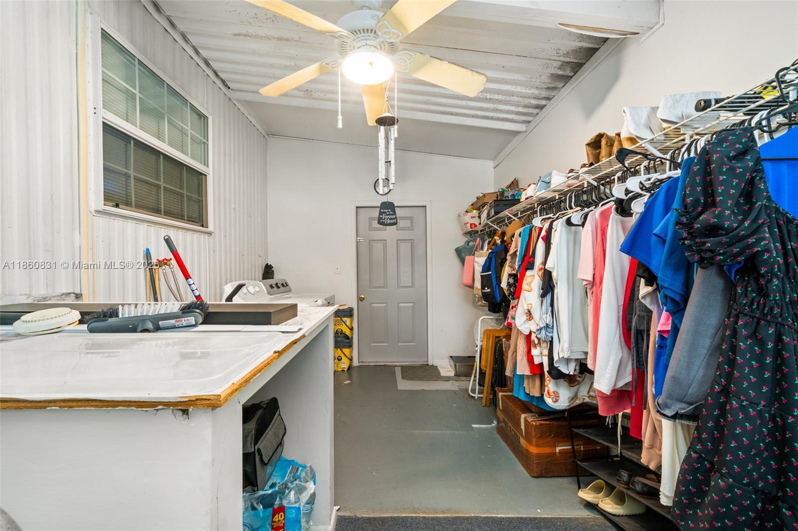 3208 Delaware Avenue Sebring, FL 33870 - Photo 20 of 37 a view of walk in closet with clothes and shoes