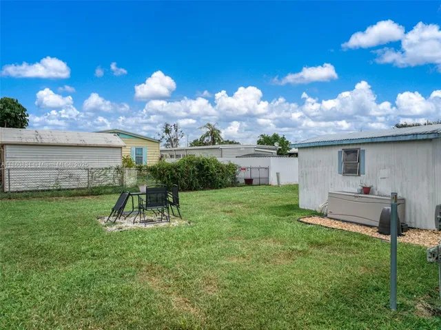 a view of a house with a backyard