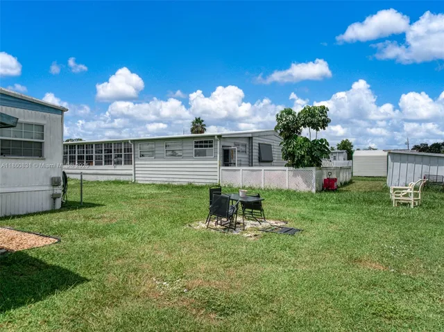 a view of a house with backyard and a garden