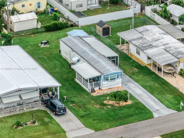 an aerial view of a house with a yard table and chairs