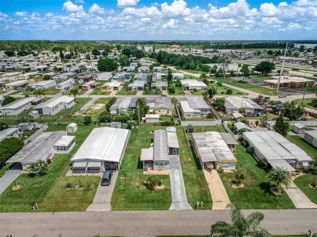 an aerial view of residential houses with outdoor space and street view