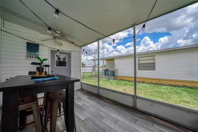 a view of a room with a table and chairs
