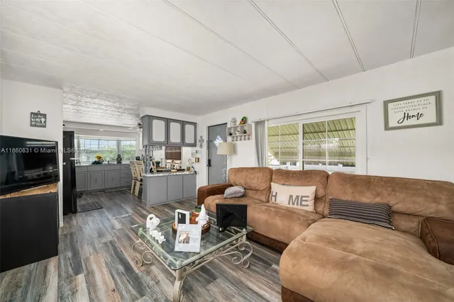a living room with furniture large window and a table