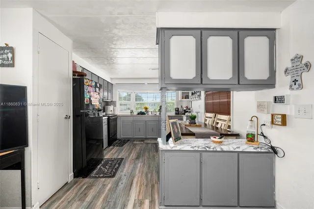 a kitchen with cabinets a sink and appliances