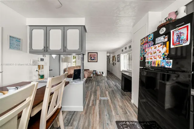 a living room with furniture a flat screen tv and a floor to ceiling window