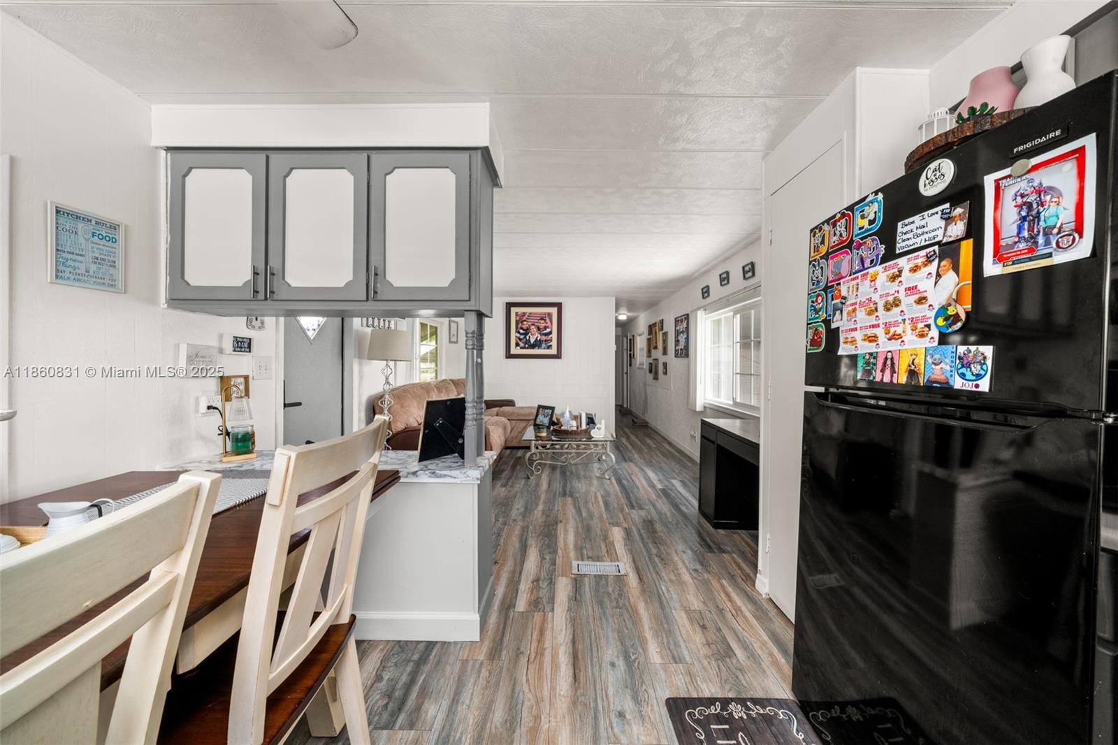 3208 Delaware Avenue Sebring, FL 33870 - Photo 10 of 37 a living room with furniture a flat screen tv and a floor to ceiling window