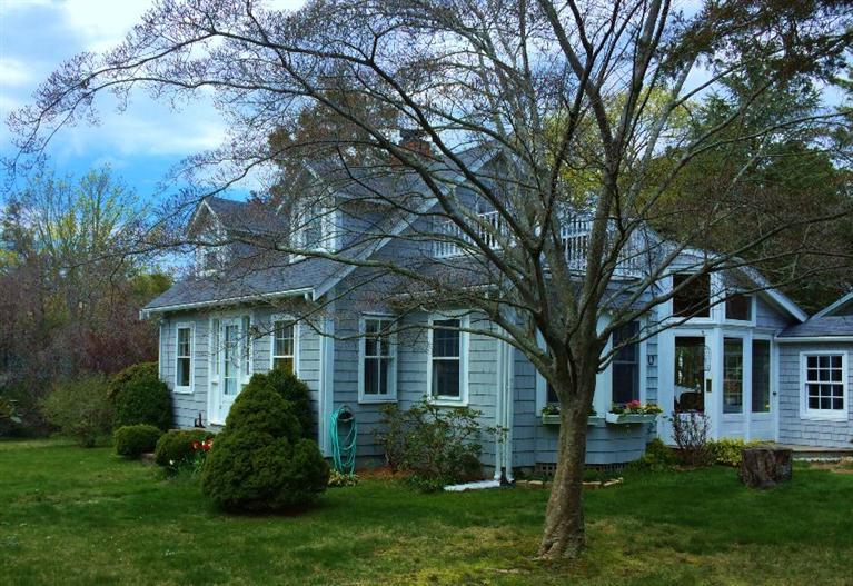 1 Wing Road Pocasset, MA 02559 - Photo 5 of 27 a front view of a house with a garden and trees