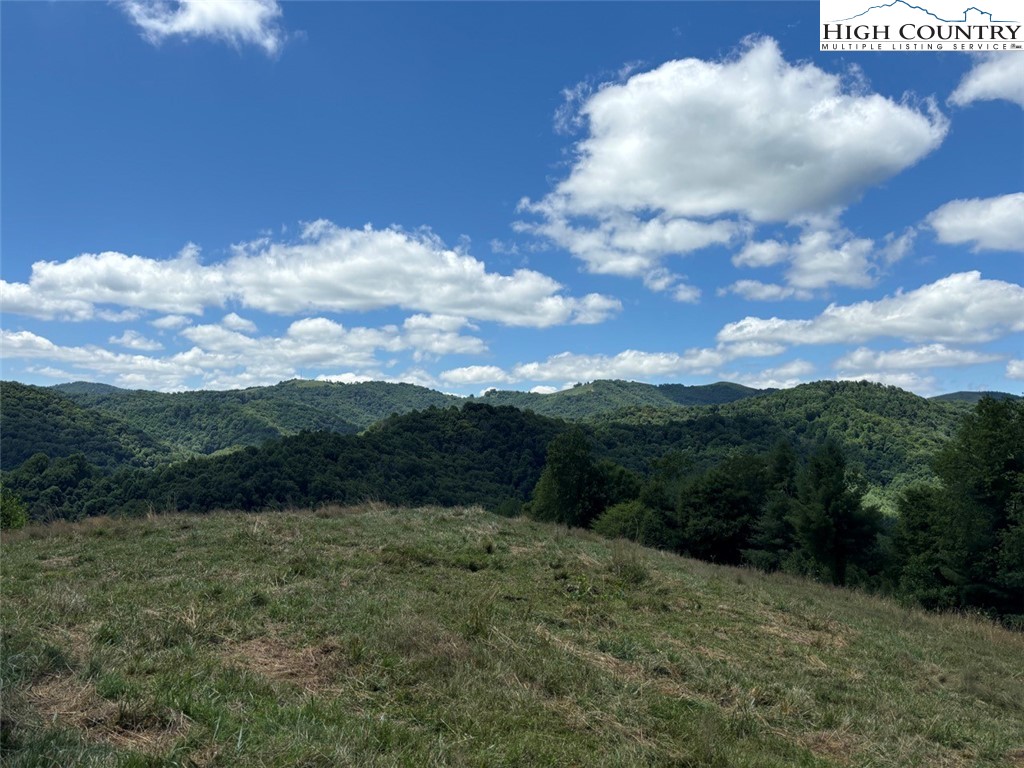 Coy Ham Road Lansing, NC 28643 - Photo 2 of 32 a view of a bunch of mountains in middle of the green field