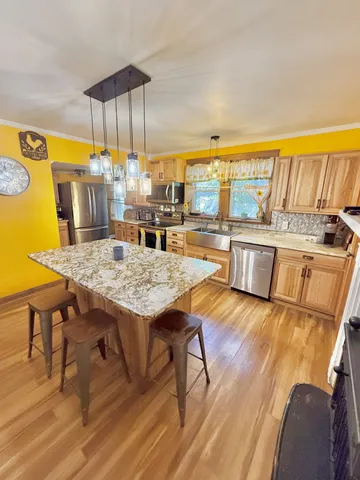 a view of a dining room with furniture and chandelier