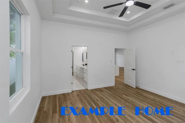 a room with a bed and a painting on the wall