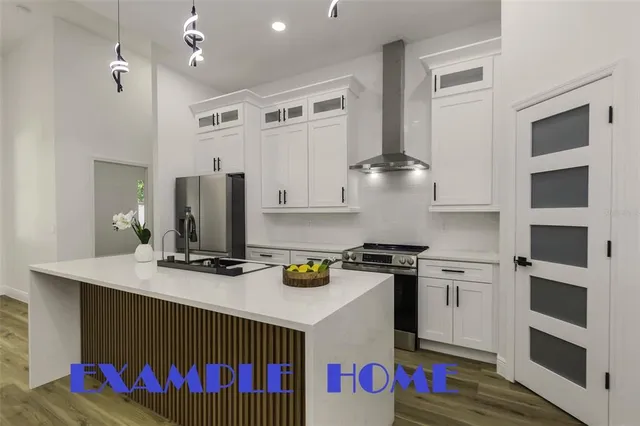 a kitchen with a stove a refrigerator and a microwave