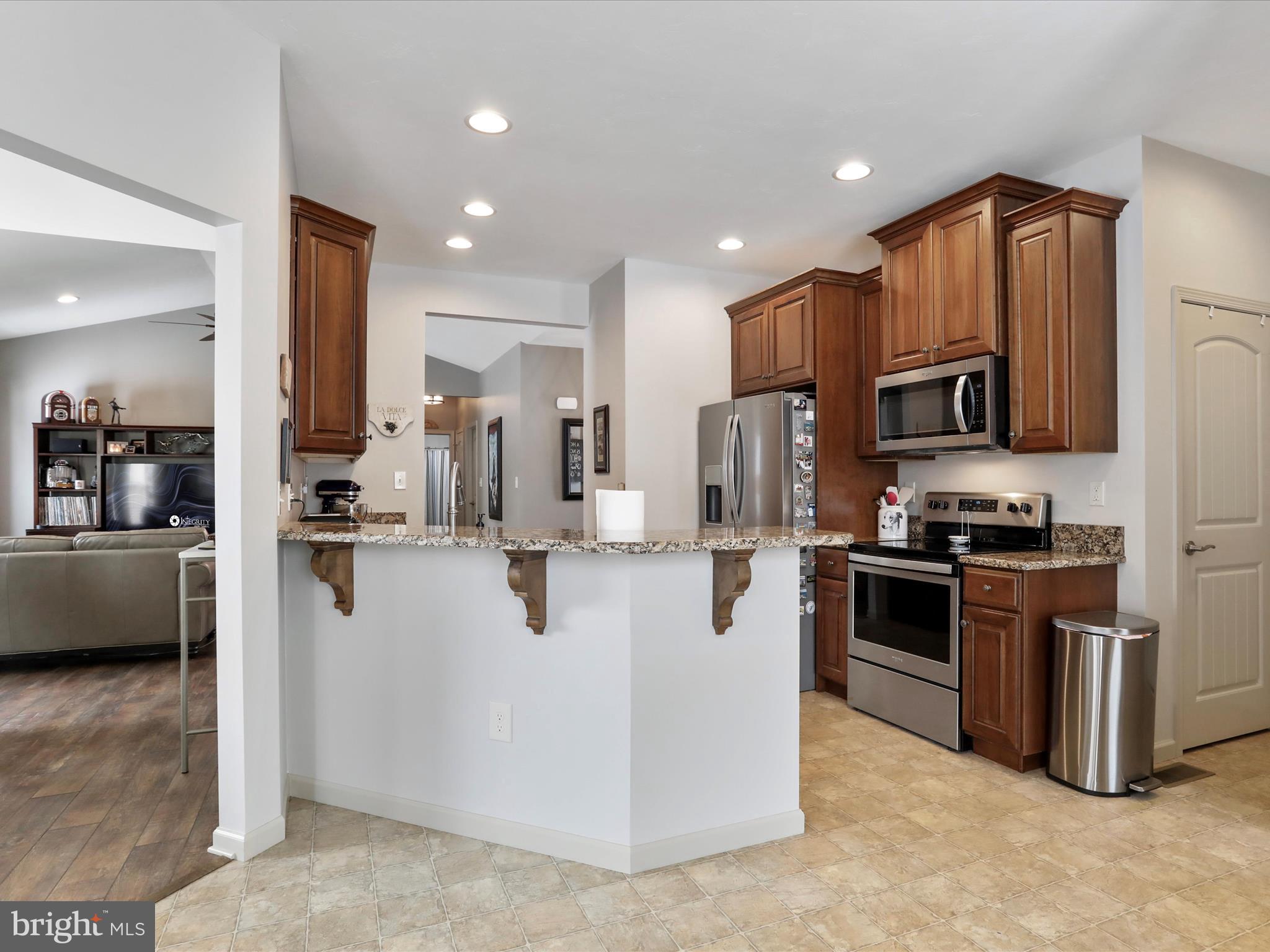 416 Castleton Drive Chambersburg, PA 17202 - Photo 18 of 51 a kitchen with stainless steel appliances granite countertop a stove a refrigerator a sink a oven and a granite counter tops