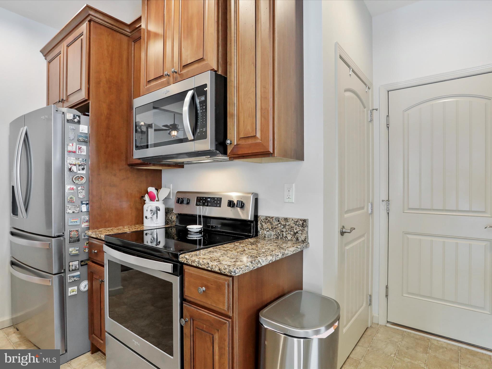 416 Castleton Drive Chambersburg, PA 17202 - Photo 19 of 51 a kitchen with stainless steel appliances granite countertop a stove a refrigerator and a microwave