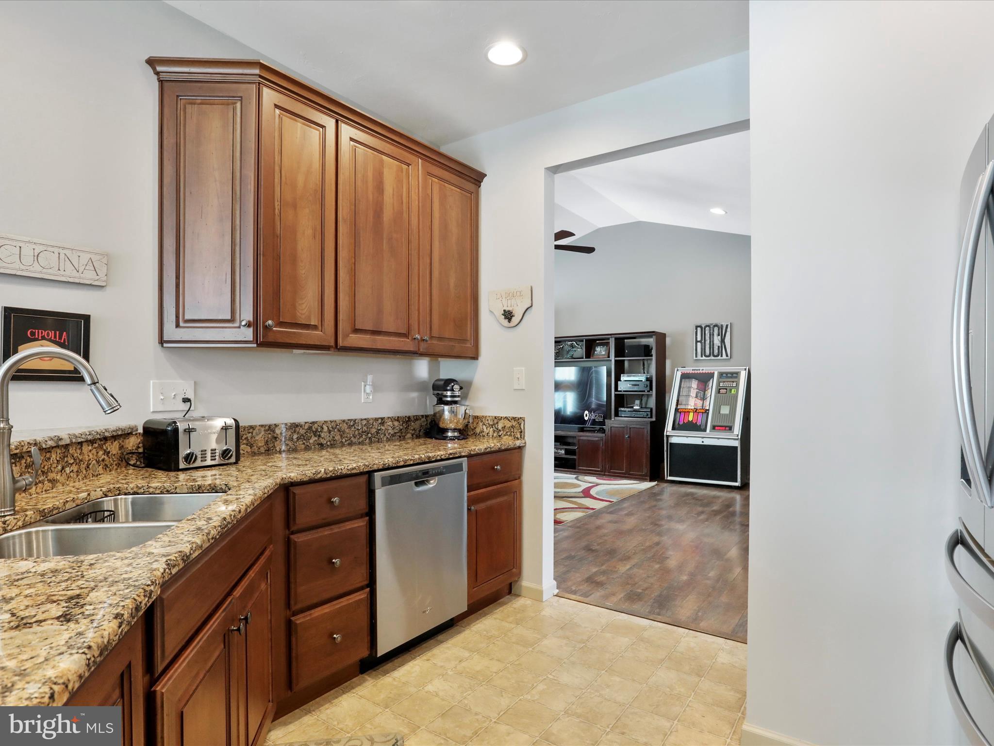 416 Castleton Drive Chambersburg, PA 17202 - Photo 22 of 51 a kitchen with stainless steel appliances granite countertop a stove a sink and a refrigerator