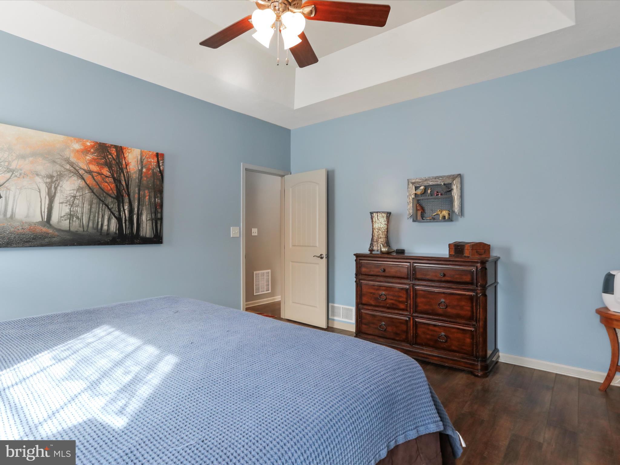 416 Castleton Drive Chambersburg, PA 17202 - Photo 25 of 51 a bedroom with a bed and a chandelier