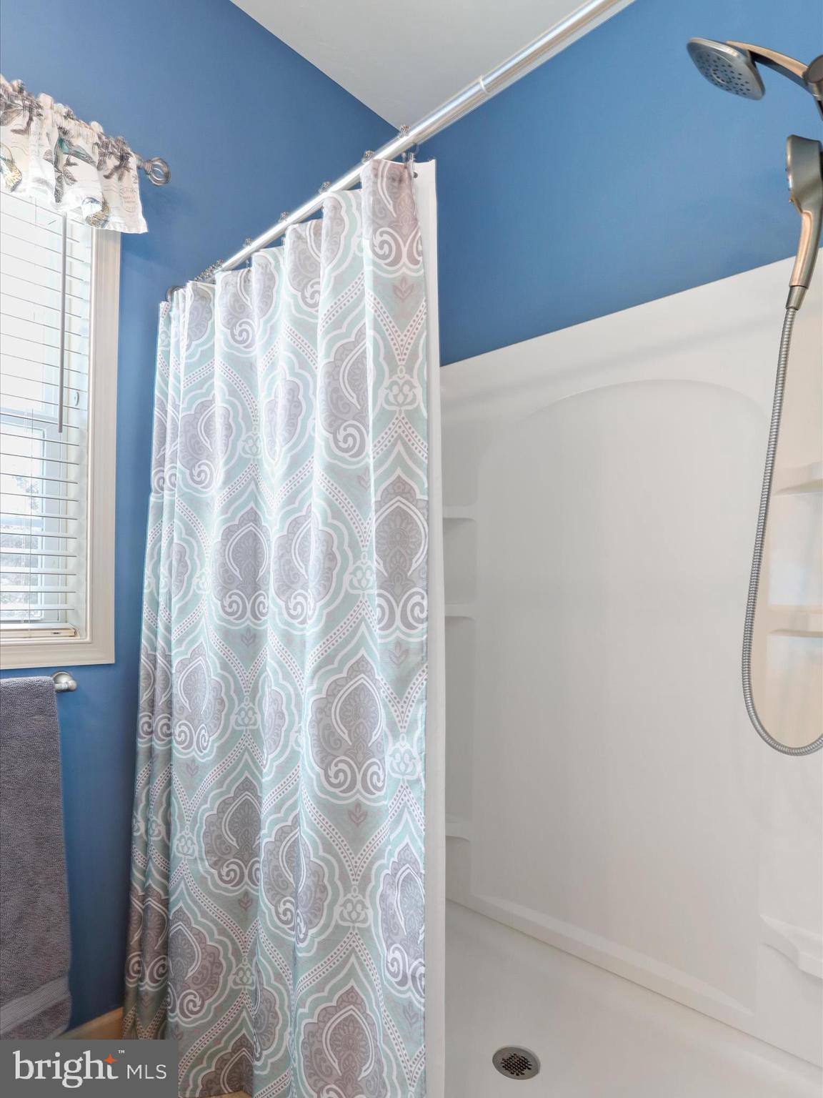 416 Castleton Drive Chambersburg, PA 17202 - Photo 29 of 51 a bathroom with a shower curtain and a window