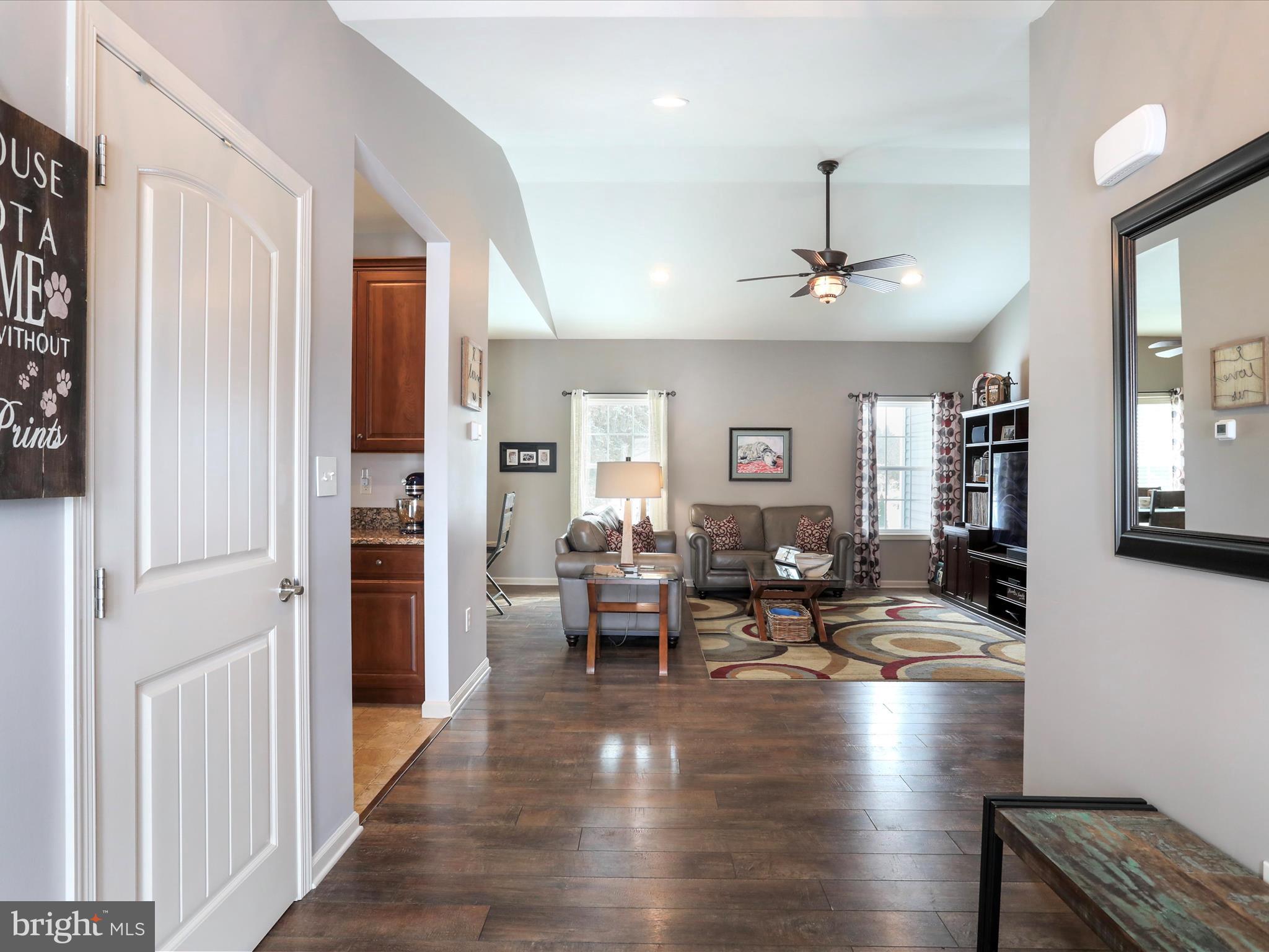 416 Castleton Drive Chambersburg, PA 17202 - Photo 5 of 51 a living room with couches and kitchen view with wooden floor