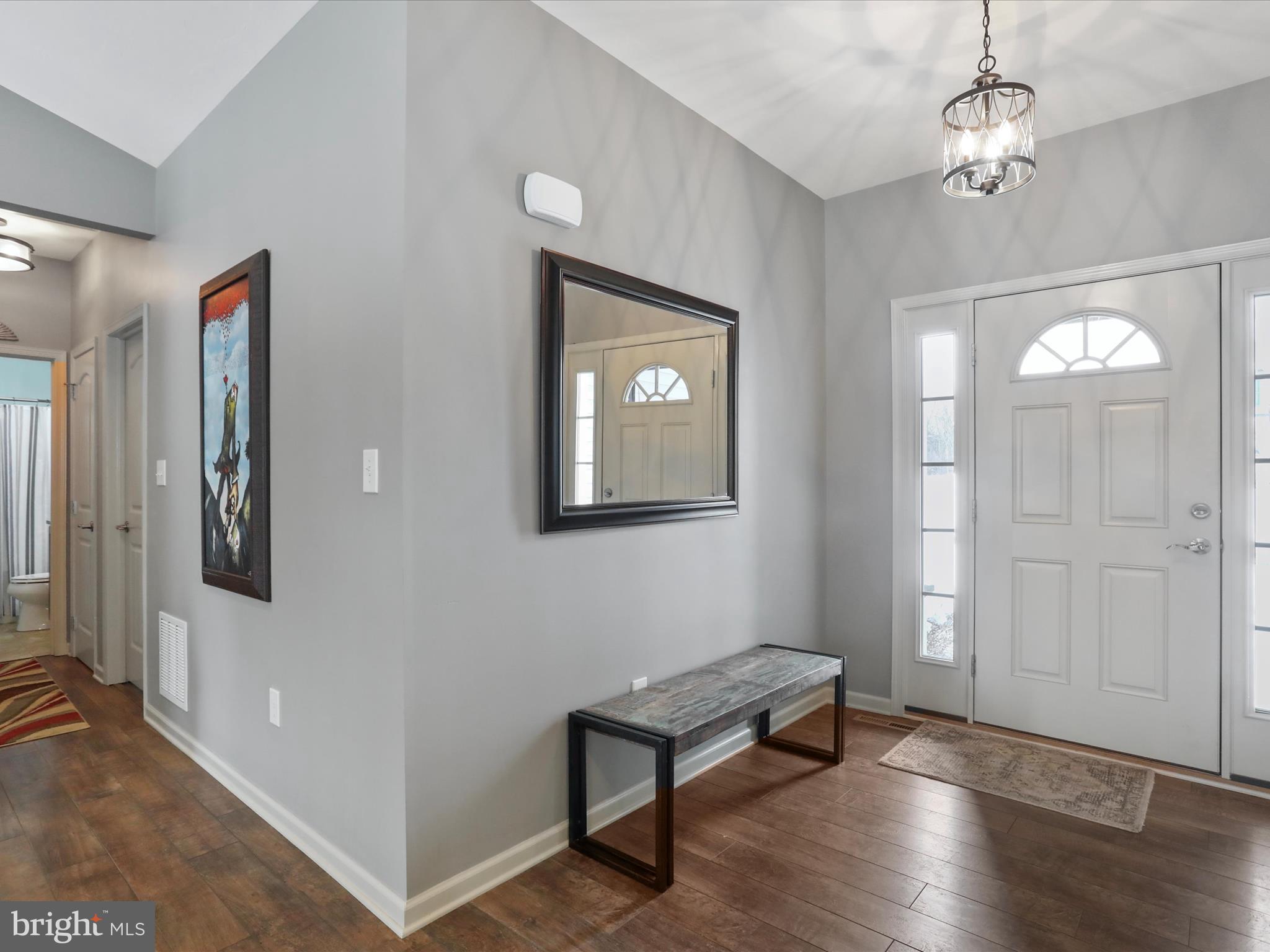 416 Castleton Drive Chambersburg, PA 17202 - Photo 6 of 51 a view of an empty room with wooden floor and windows