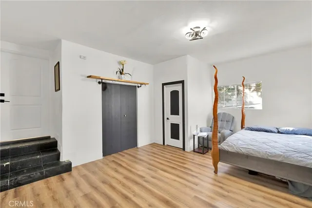 a bedroom with a bed and a dresser