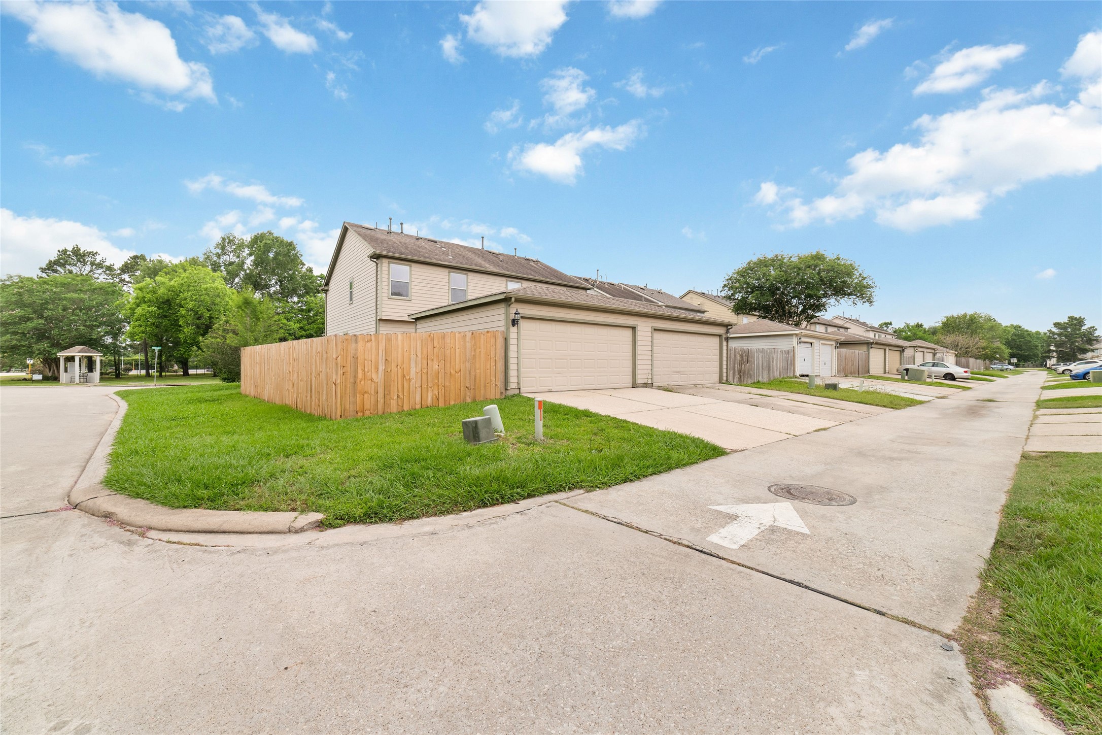 23602 Youpon Lake Lane Spring, TX 77373 - Photo 21 of 21 Rear exterior view featuring detached garage access, fenced yard space, and a quiet neighborhood setting.