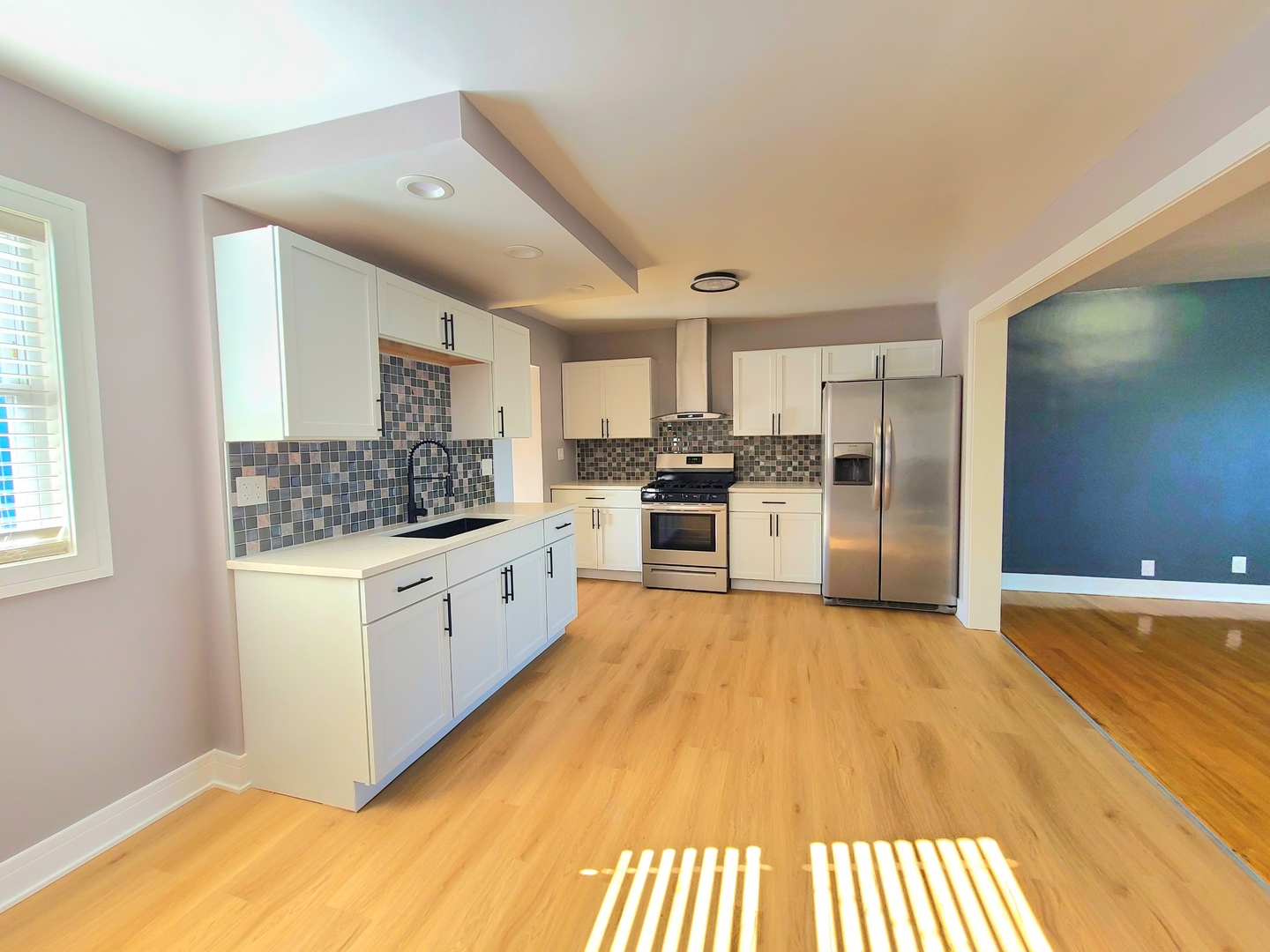 3801 West 63rd Place Chicago, IL 60629 - Photo 12 of 36 a large white kitchen with a refrigerator a stove top oven a sink and dishwasher