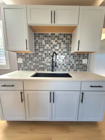 a kitchen with a sink and cabinets