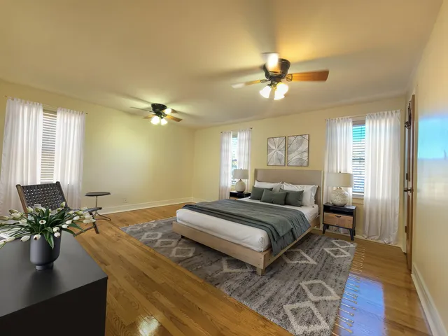 a bedroom with a bed and wooden floor