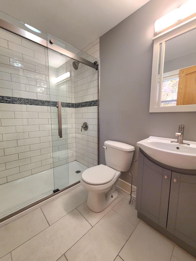 3801 West 63rd Place Chicago, IL 60629 - Photo 20 of 36 a bathroom with a toilet sink and shower