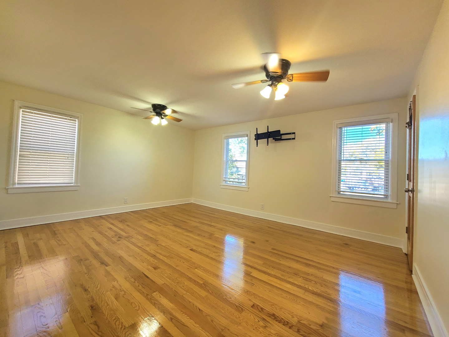 3801 West 63rd Place Chicago, IL 60629 - Photo 22 of 36 a view of empty room with wooden floor and fan