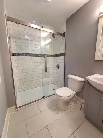a bathroom with a toilet and a shower