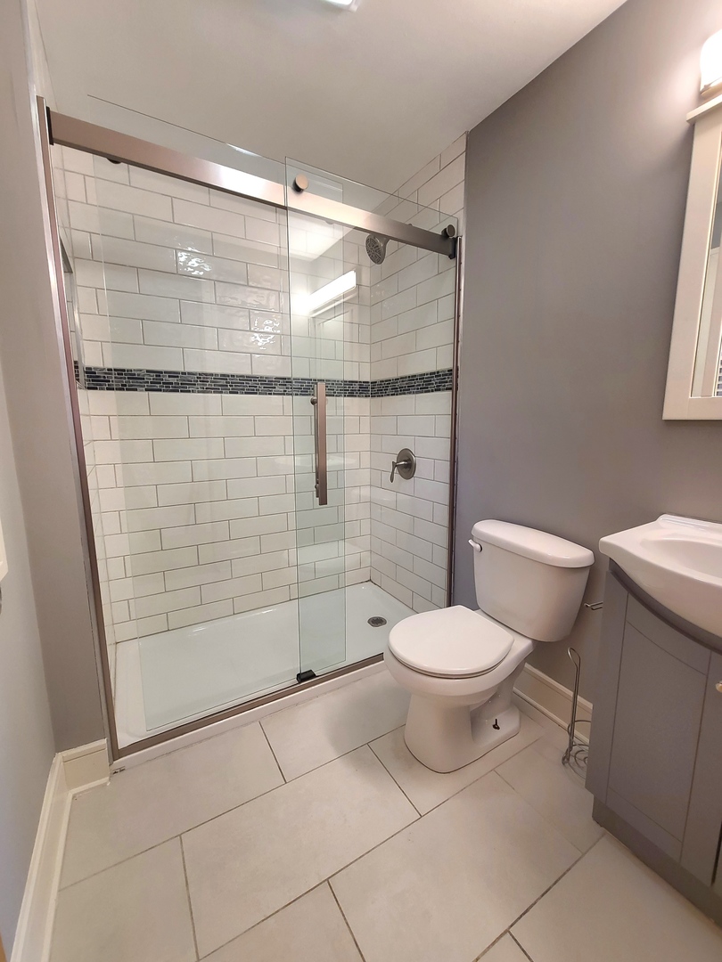3801 West 63rd Place Chicago, IL 60629 - Photo 24 of 36 a bathroom with a toilet and a shower