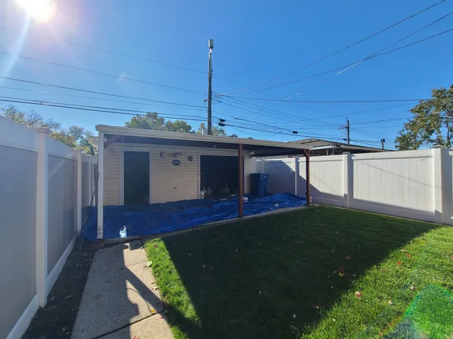 a view of a backyard with plants and a patio