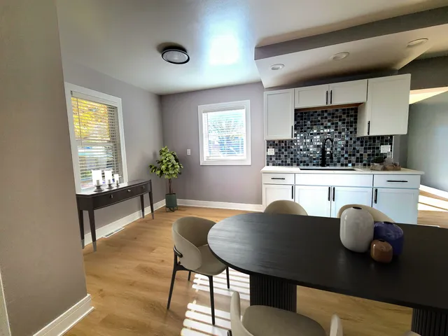 a living room with furniture and a potted plant