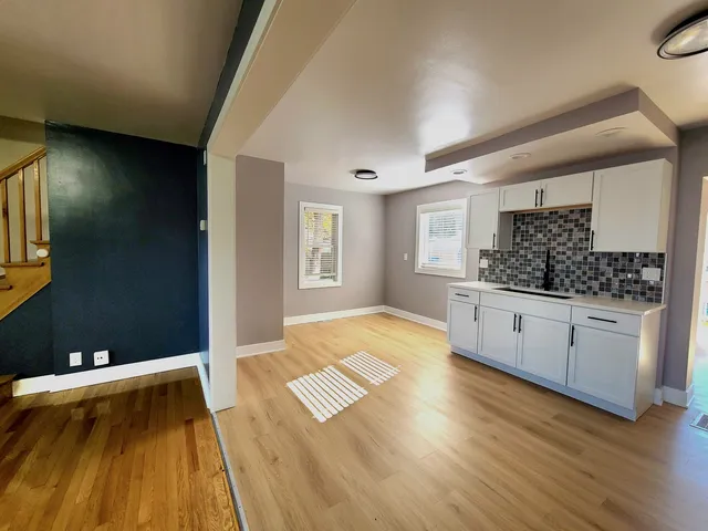a spacious bathroom with a granite countertop sink and a mirror