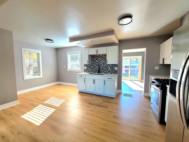 a view of kitchen with sink and wooden floor