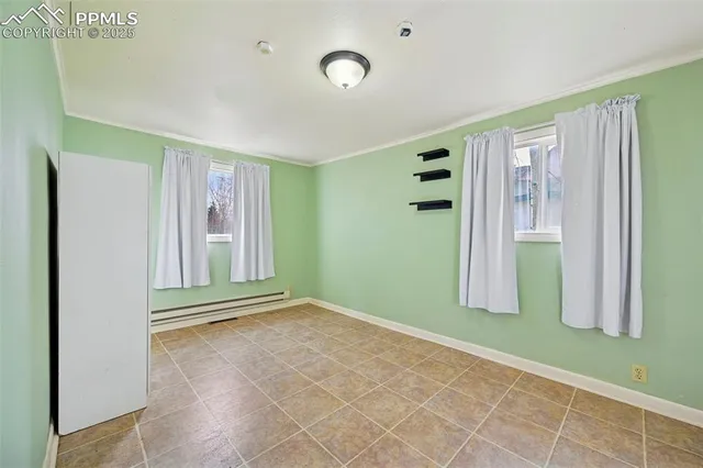 a view of an empty room with window and stairs