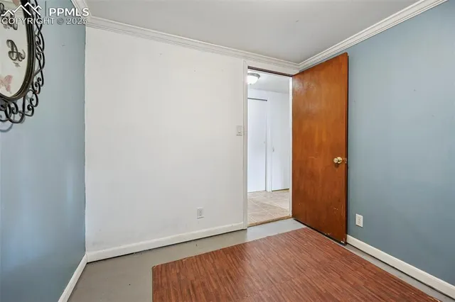 an empty room with wooden floor and a window