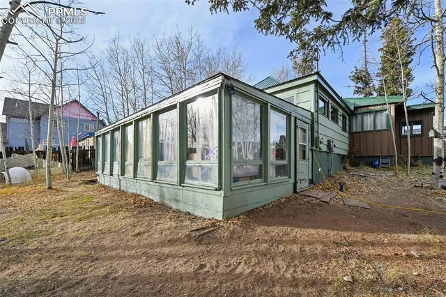 a view of a house with backyard and sitting area
